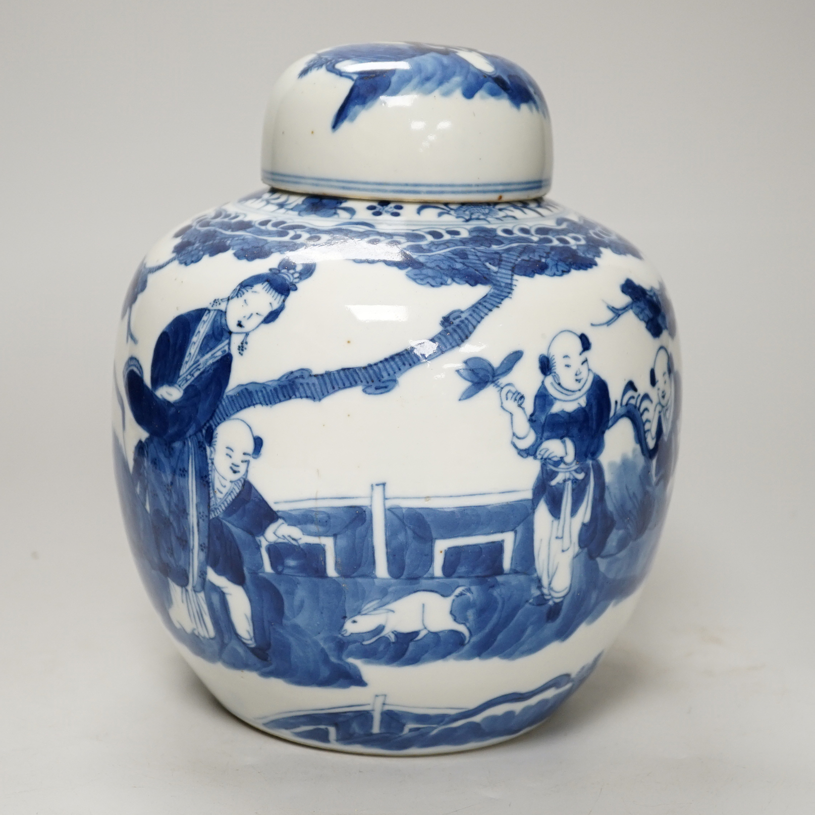 A 19th century Chinese blue and white jar and cover, hand painted with figures in a landscape, 20cm high